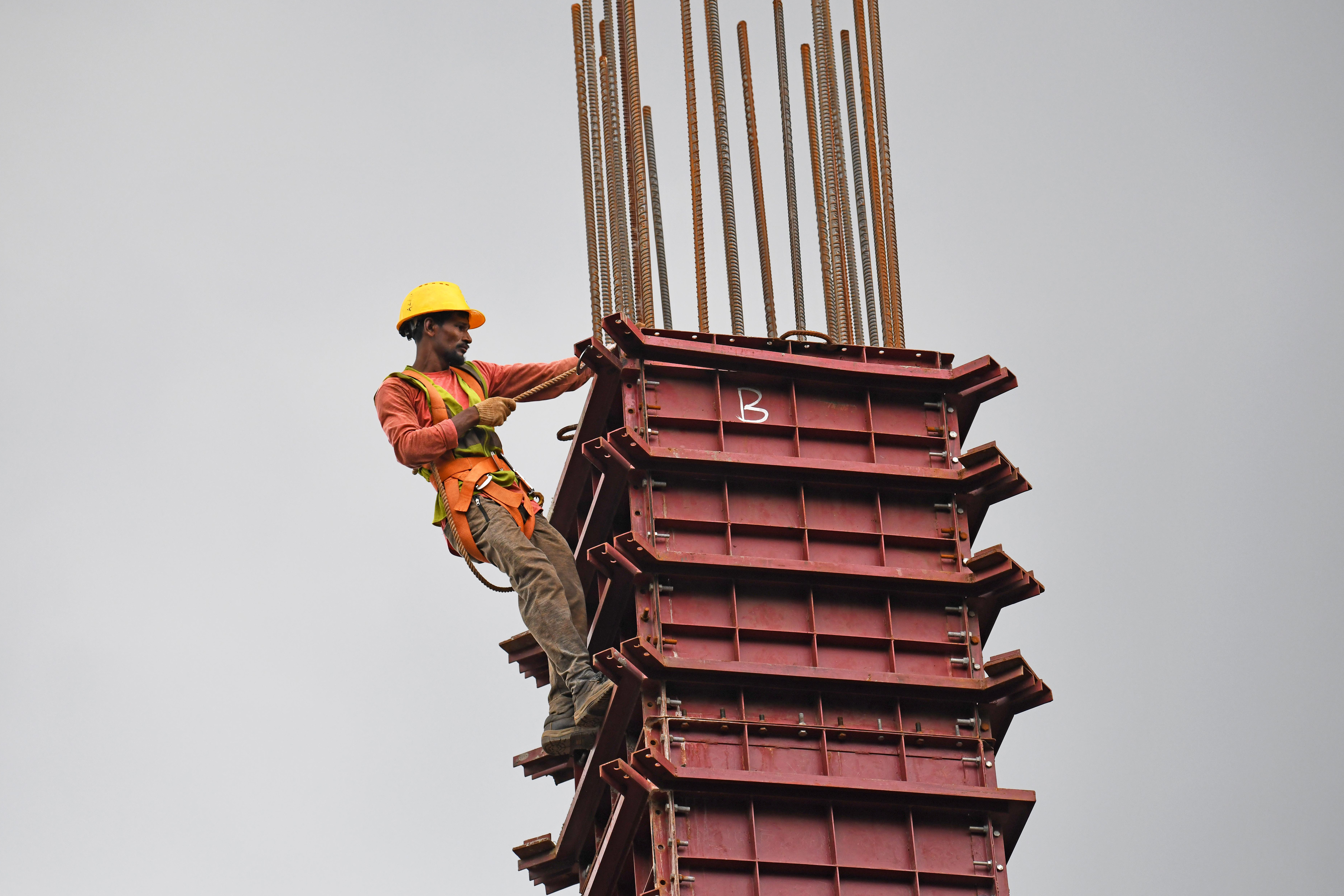 Construction worker on a rebar tower